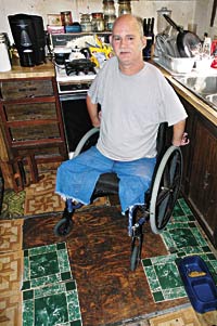 Floor sags under man’s wheelchair; he seeks help